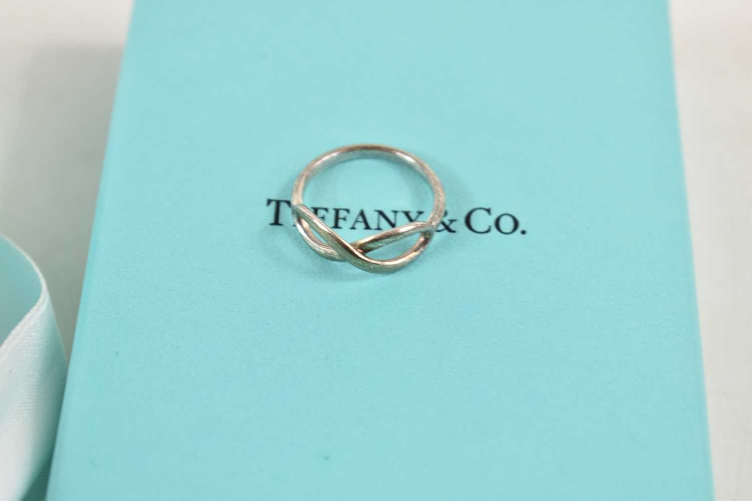 A silver Tiffany and Co Infinity ring, marked inside shank T&Co. AG925, size L, 2.09g, complete with - Image 2 of 2
