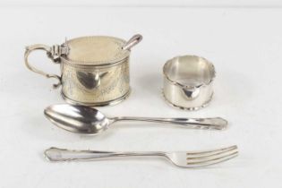 A Victorian silver mustard pot and spoon, the pot having a blue glass liner, the body decorated with