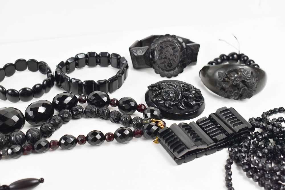 A large group of Victorian and later jet necklaces and bracelets, including a faceted jet three - Image 2 of 3
