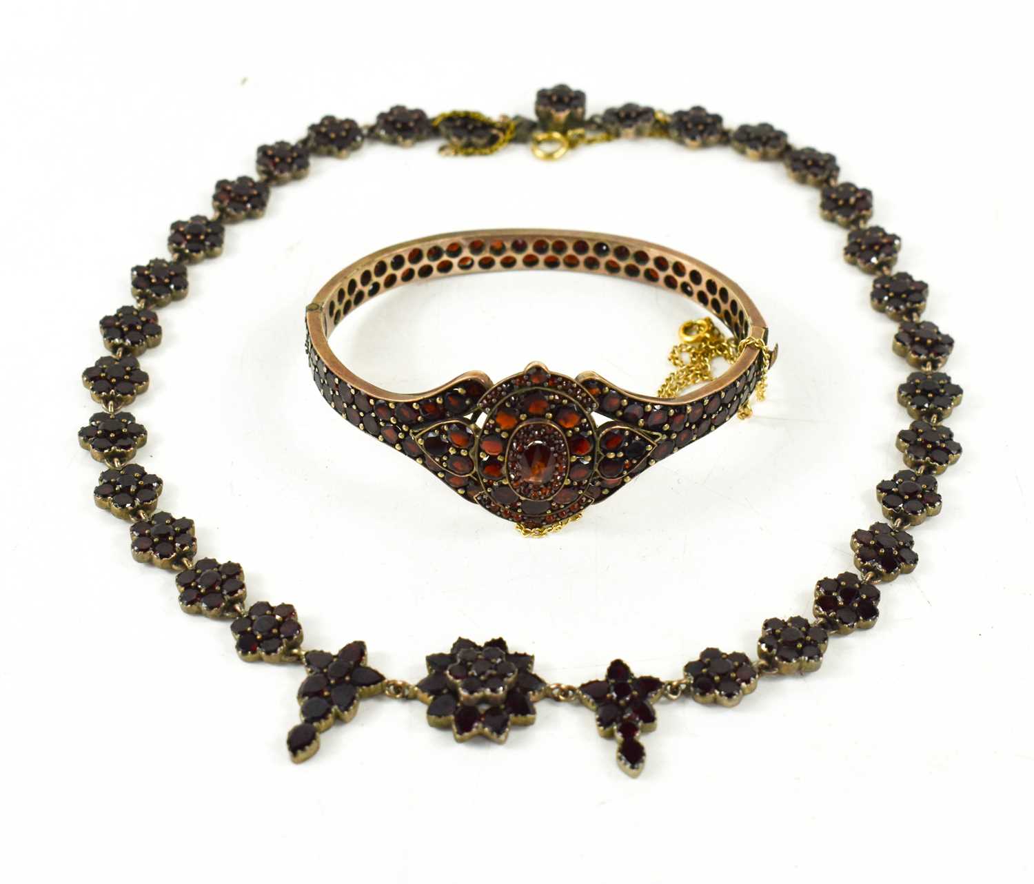 A 19th century gilt metal and garnet bangle and matching necklace, the oval centre piece flanked - Image 3 of 5
