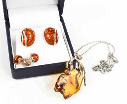 A silver and amber pendant and chain, possibly Baltic amber, together with two pairs of silver and