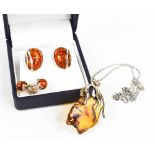 A silver and amber pendant and chain, possibly Baltic amber, together with two pairs of silver and