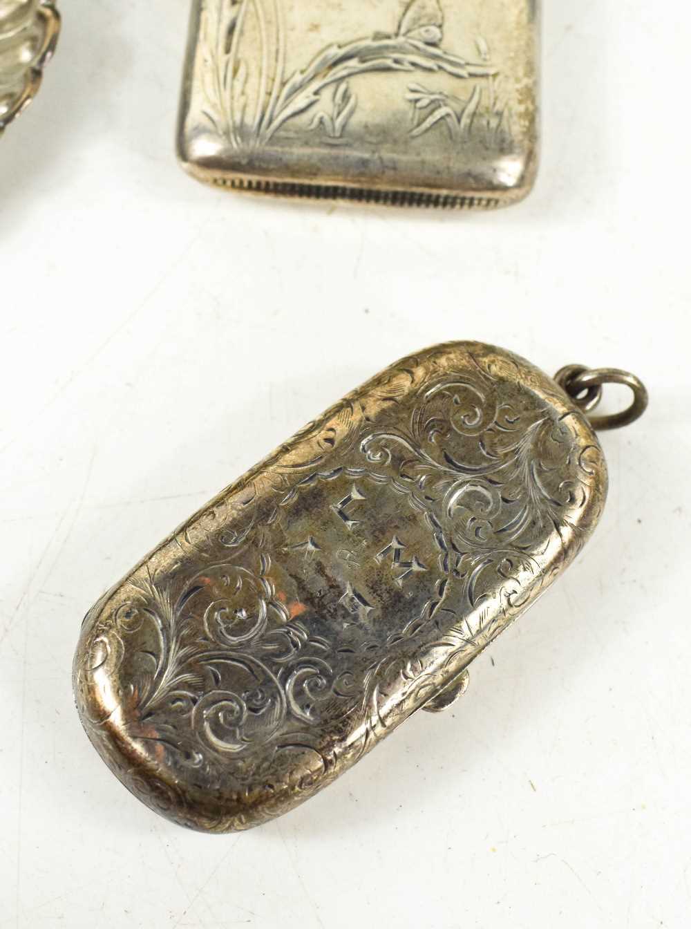A group of silver to include two embossed trinket dishes, a coin case decorated with chased - Image 2 of 2