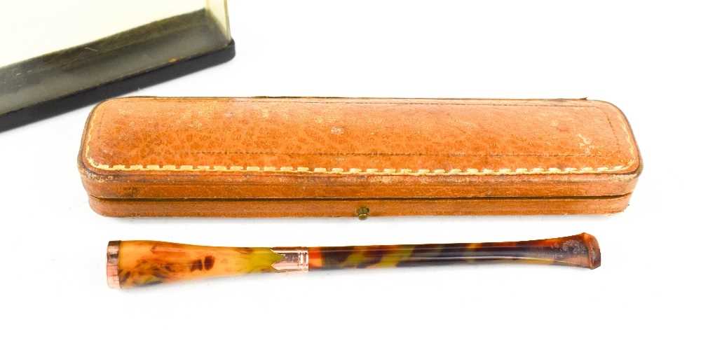 A vintage cigarette holder, of faux tortoiseshell with 9ct gold rim and collar, together with a