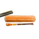 A vintage cigarette holder, of faux tortoiseshell with 9ct gold rim and collar, together with a
