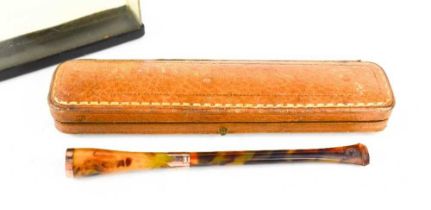 A vintage cigarette holder, of faux tortoiseshell with 9ct gold rim and collar, together with a