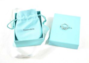 A silver Tiffany and Co Infinity ring, marked inside shank T&Co. AG925, size L, 2.09g, complete with