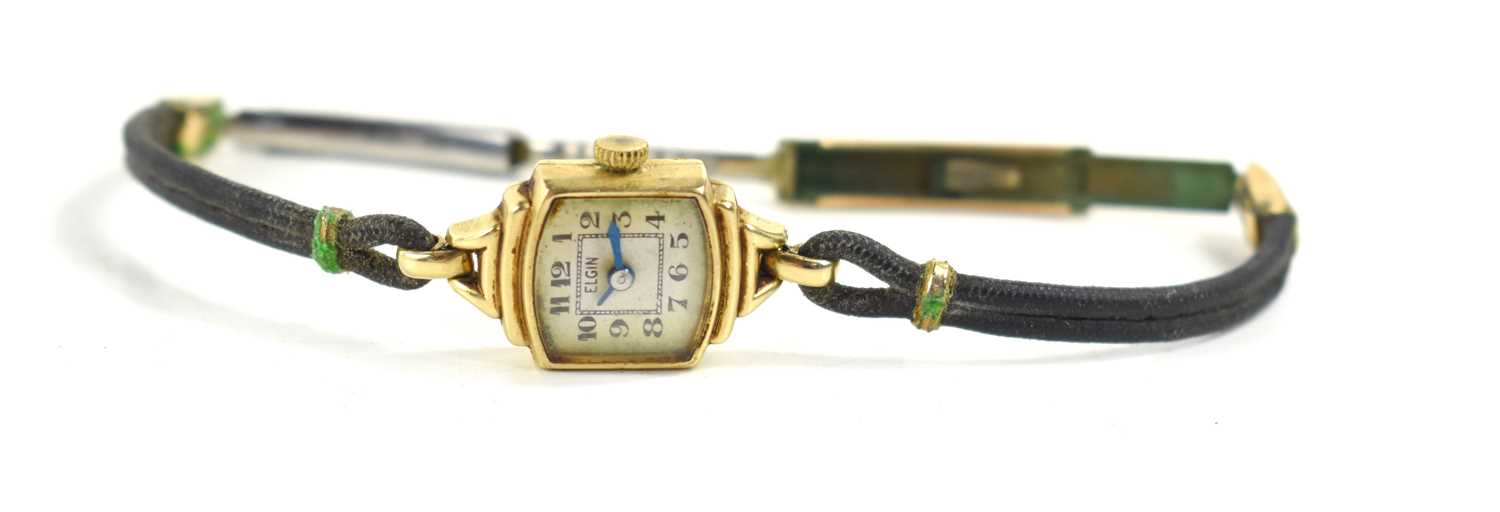 An Elgin Art Deco 14k gold cased ladies wristwatch with cord strap and yellow metal clasp.