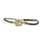 An Elgin Art Deco 14k gold cased ladies wristwatch with cord strap and yellow metal clasp.