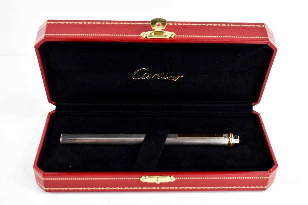 A Cartier ball point pen, with rose, yellow and white gold band to the pen lid, no.475802, in the