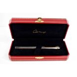 A Cartier ball point pen, with rose, yellow and white gold band to the pen lid, no.475802, in the