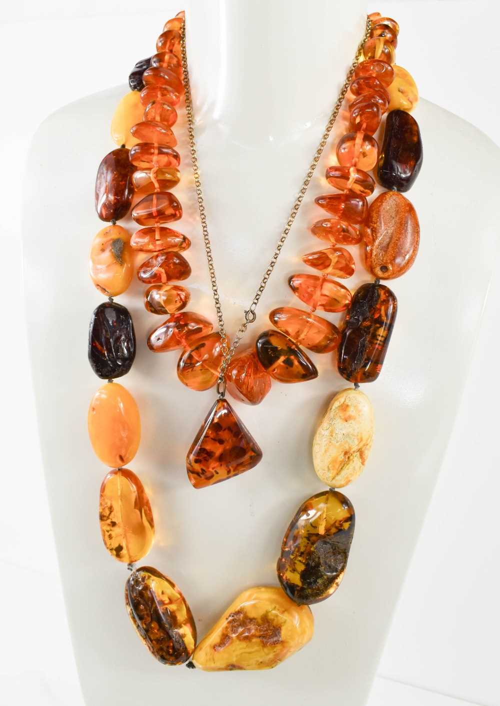 A string of vintage amber, possibly Baltic, of oval naturalistic form, polished to reveal