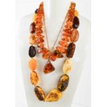 A string of vintage amber, possibly Baltic, of oval naturalistic form, polished to reveal