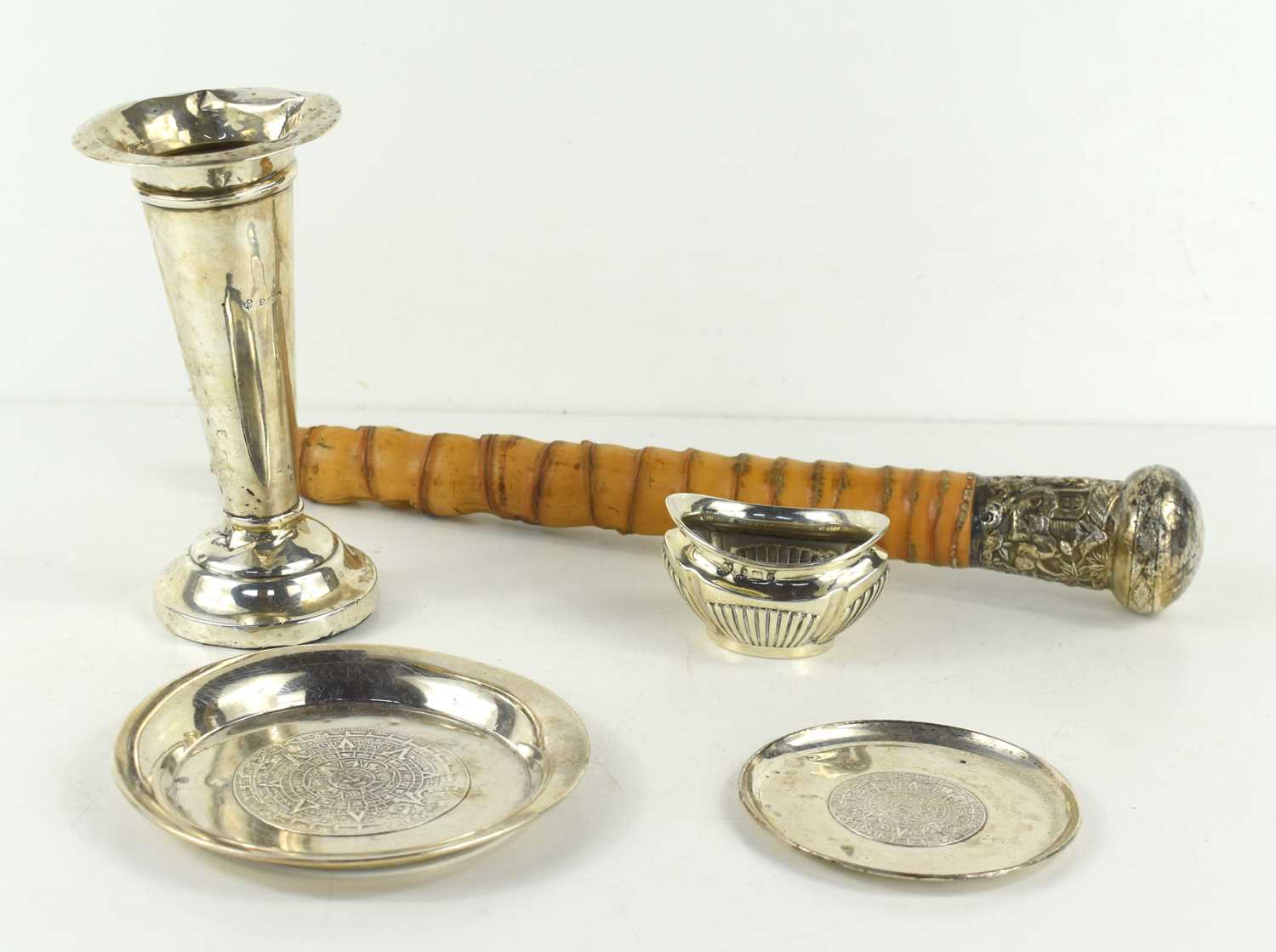 Two sterling silver Mexican dishes, a silver bud vase with weighted base, a silver salt, a white