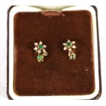 A pair of 9ct gold, diamond and emerald earrings of flowerhead form with emerald drops, each