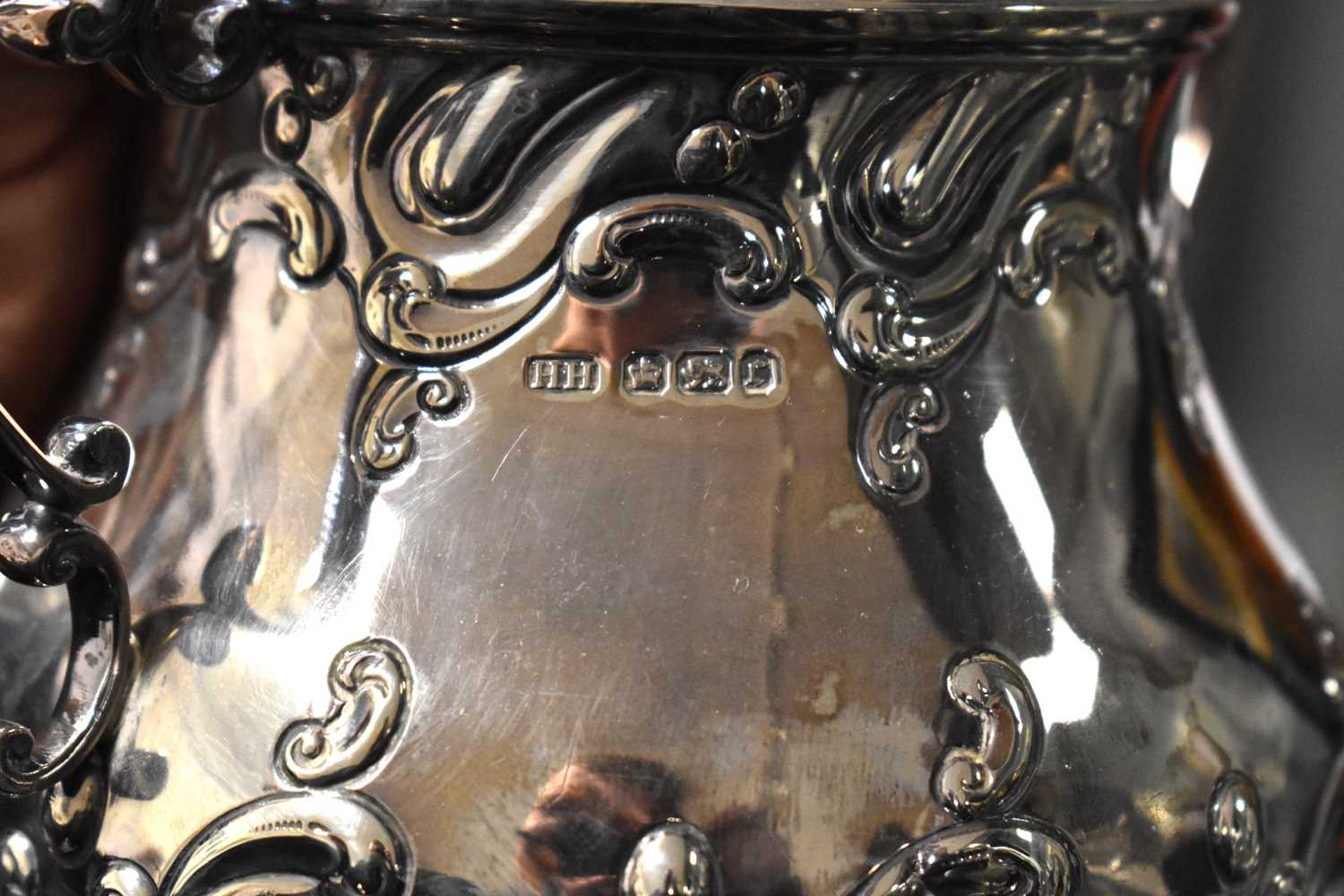 A silver tea set, embossed with Rococo style scrollwork, comprising tea pot, water pot, sugar - Image 3 of 4