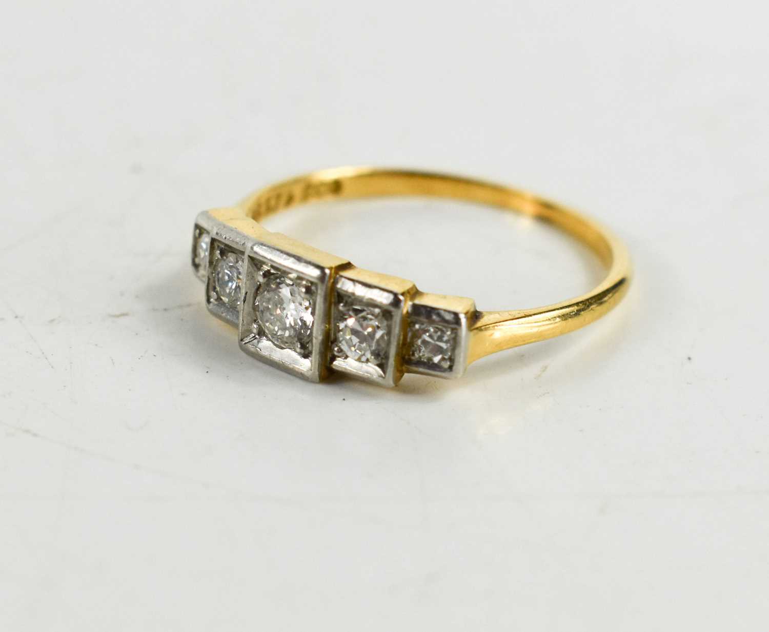 An 18ct gold, diamond and platinum ring, the five graduated brilliant cut diamonds in staggered