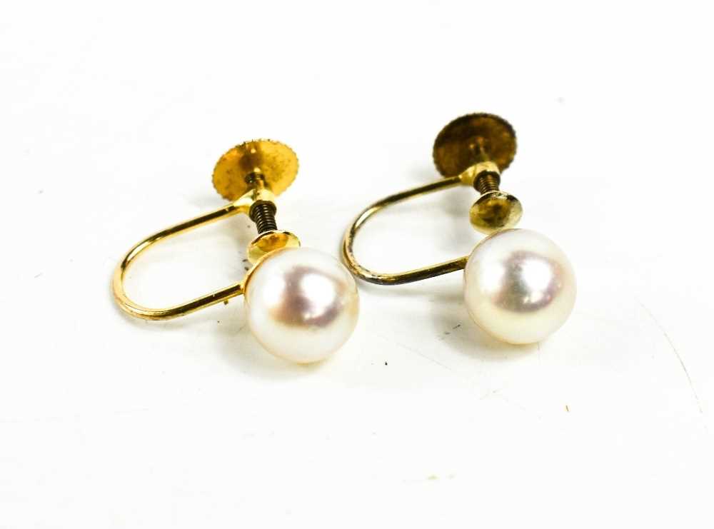 A pair of 9ct gold and pearl earrings, the single pearls adjoin the hoop and screw backs.