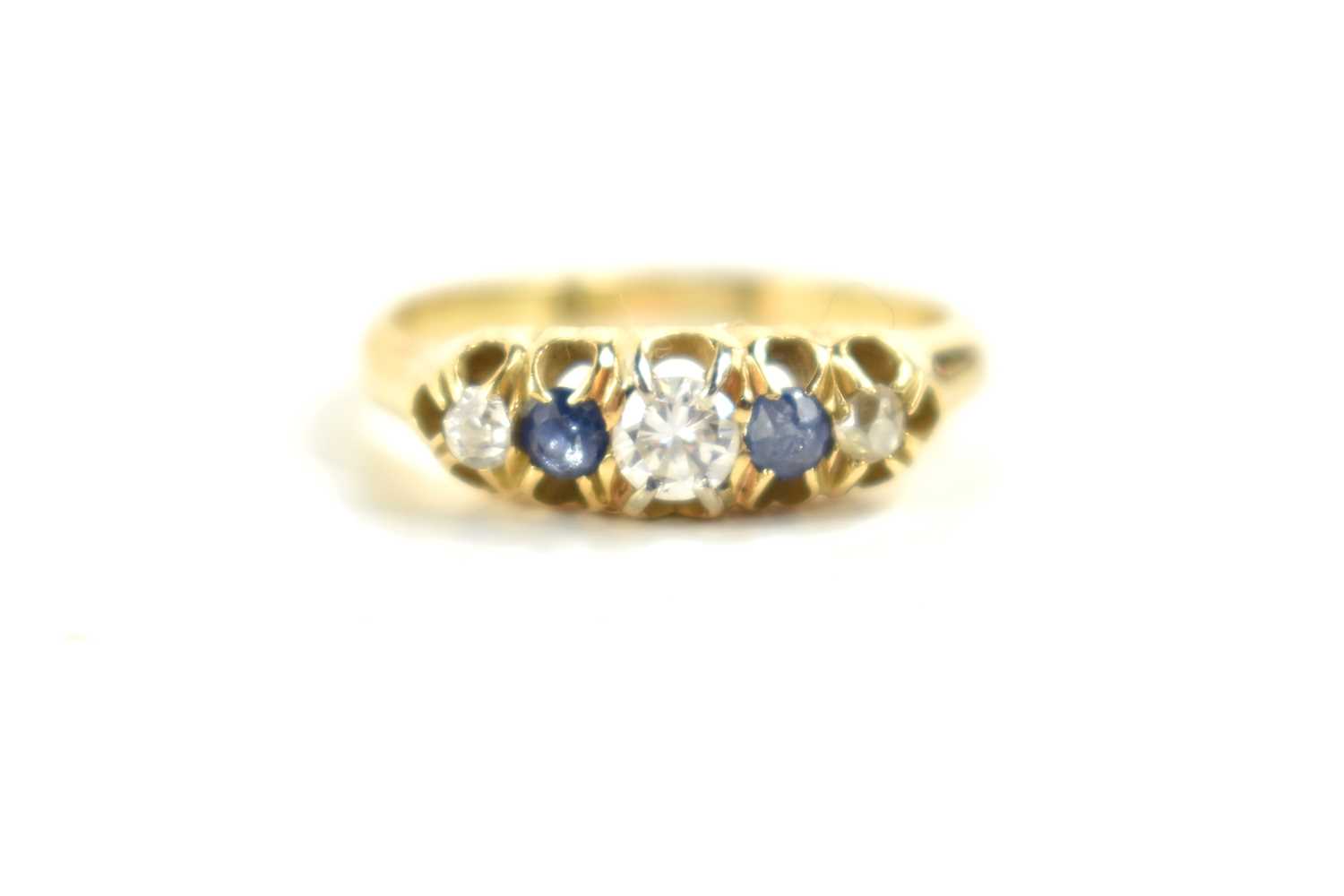 An 18ct gold, diamond and sapphire five stone ring, the central, largest diamond of approximately