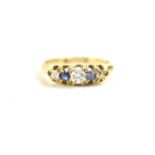 An 18ct gold, diamond and sapphire five stone ring, the central, largest diamond of approximately