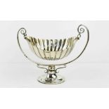 A silver scalloped bowl on stand with twin scroll form handles supporting the suspended bowl,