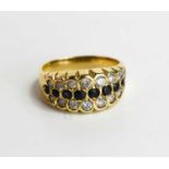 A 9ct gold sapphire and white stone set ring, with central band of nine deep blue amethysts, size N,