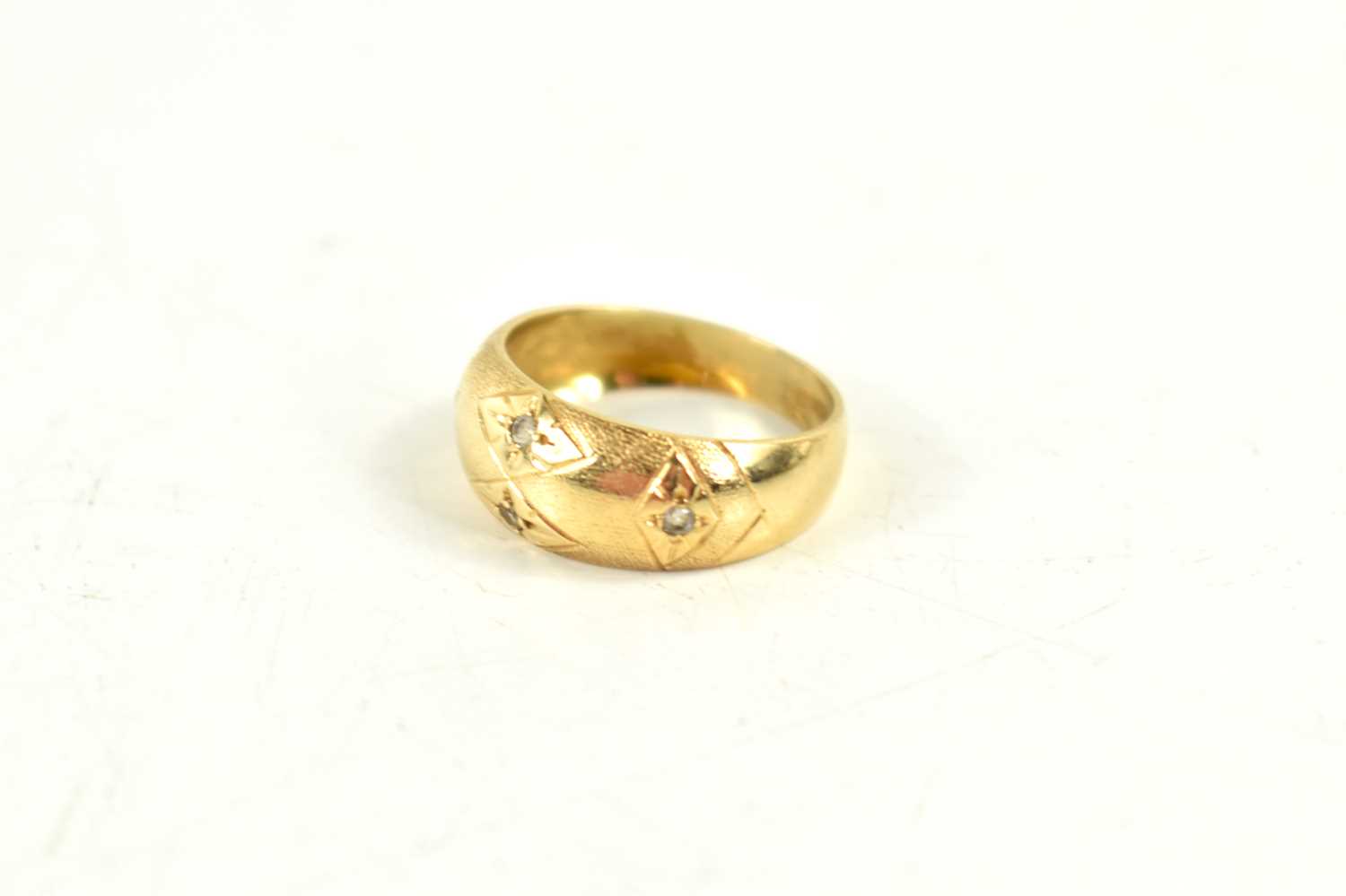 A gold and diamond gypsy ring, the four diamonds in starburst settings, indistinctly marked to the - Image 2 of 2