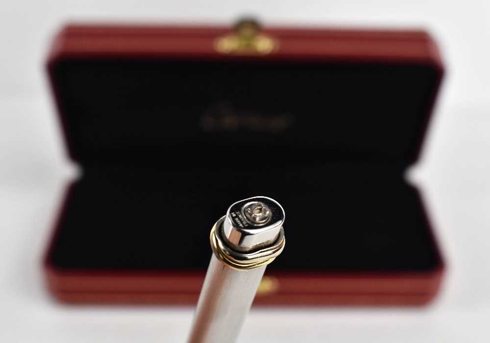 A Cartier ball point pen, with rose, yellow and white gold band to the pen lid, no.475802, in the - Image 3 of 5