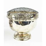 A silver flower frog, with embossed borders, footed base, London 1908, 15cms tall, 15.3toz.