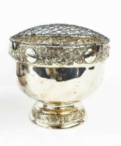A silver flower frog, with embossed borders, footed base, London 1908, 15cms tall, 15.3toz.