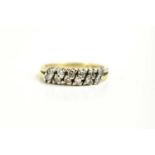 A 9ct gold and diamond twelve stone ring, the diamond brilliants set in six diagonal pairs, size