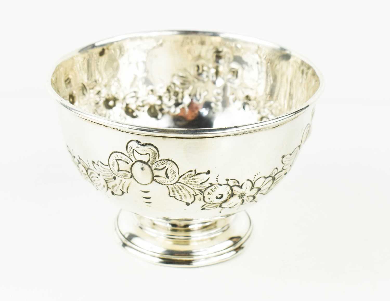 A silver bowl embossed with floral garlands, hallmarked for London 1905, 12cms diameter, 8cms