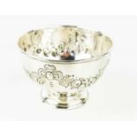 A silver bowl embossed with floral garlands, hallmarked for London 1905, 12cms diameter, 8cms