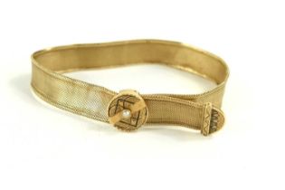 A gold (tested as 18ct) bracelet of mesh form, having an adjustable fastener set with a single