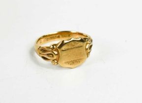 A 9ct gold signet ring, of shield form with scroll shoulders, size V, 7.8g.