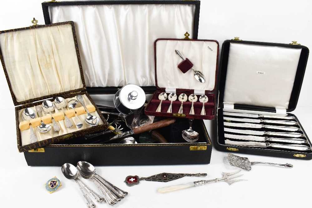 A set of six silver handled butter knives, a set of six silver spoons and a silver plated set of tea