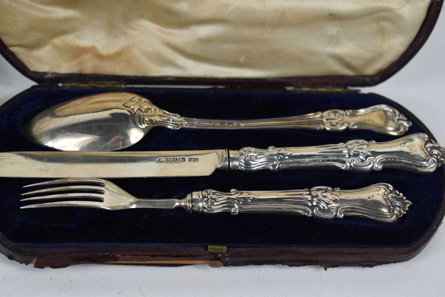 A silver knife, fork and spoon set, the solid silver fork and knife with silver clad handles, in the - Image 2 of 2