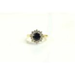 An 18ct gold, sapphire and diamond flowerhead ring, the central stone of approximately 6.1mm,