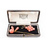 A 9ct gold and coral set stick pin, 6.44g including coral and a similar vintage coral brooch.