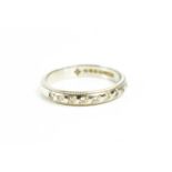 A platinum and diamond seven stone half eternity ring, with beaded edges, size K, 3.5g.