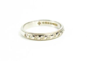 A platinum and diamond seven stone half eternity ring, with beaded edges, size K, 3.5g.