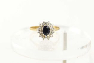 A 9ct gold, sapphire and diamond cluster ring, the central oval sapphire of approximately 6.1 by 4.