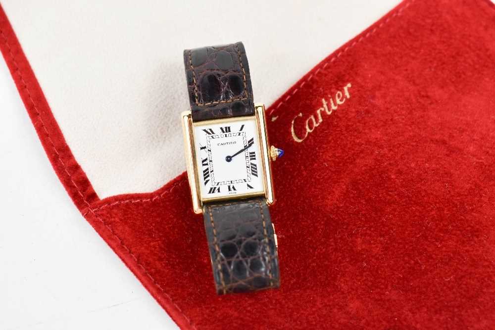 An 18ct gold cased Cartier tank watch, the signed white rectangular dial with Roman numerals and