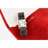 An 18ct gold cased Cartier tank watch, the signed white rectangular dial with Roman numerals and