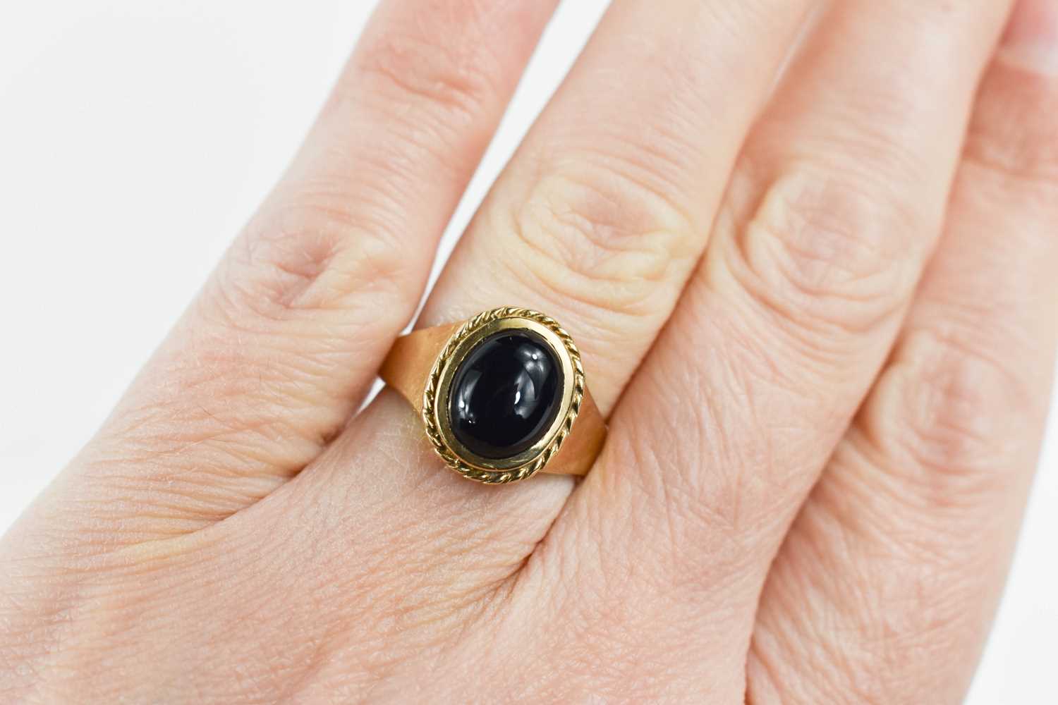 A 9ct gold ring set with an oval dark cabochon stone, size L, 4.09g. - Image 2 of 2