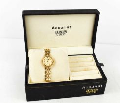 A lady's Accurist 9ct gold cased wristwatch. the signed dial with batton numerals, and with 9ct gold