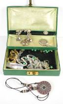 A silver charm bracelet with thirty two mostly silver charms together with a jewellery box and