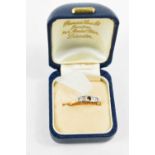 An 18ct gold, platinum and diamond Art Deco five stone ring, with scroll setting, a/f central