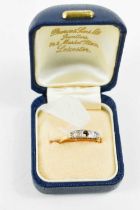 An 18ct gold, platinum and diamond Art Deco five stone ring, with scroll setting, a/f central