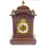 An early 20th century mahogany cased Junghans mantle clock, the dial with scroll spandrels and